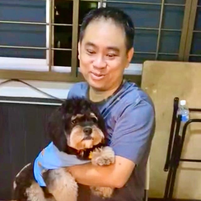 Handsome Francis holding his dog